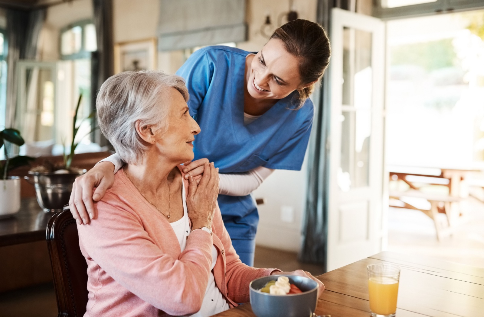 A staff member connects with a resident in memory care.