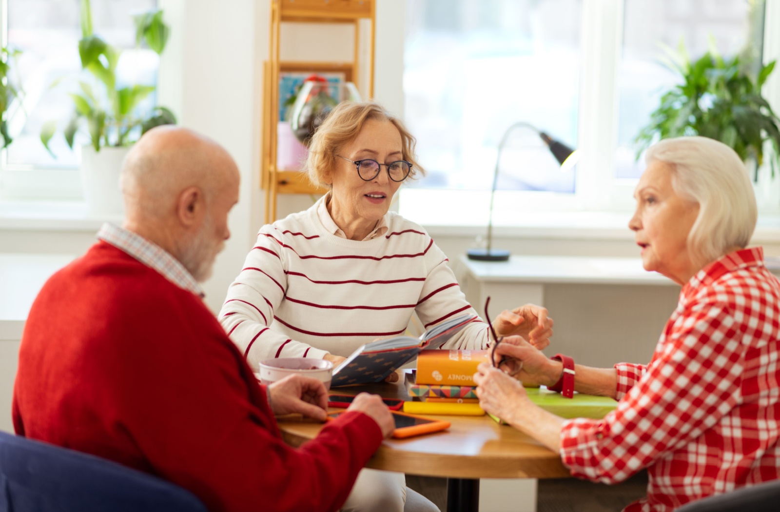 A small group of older adults in a book club, discussing books.