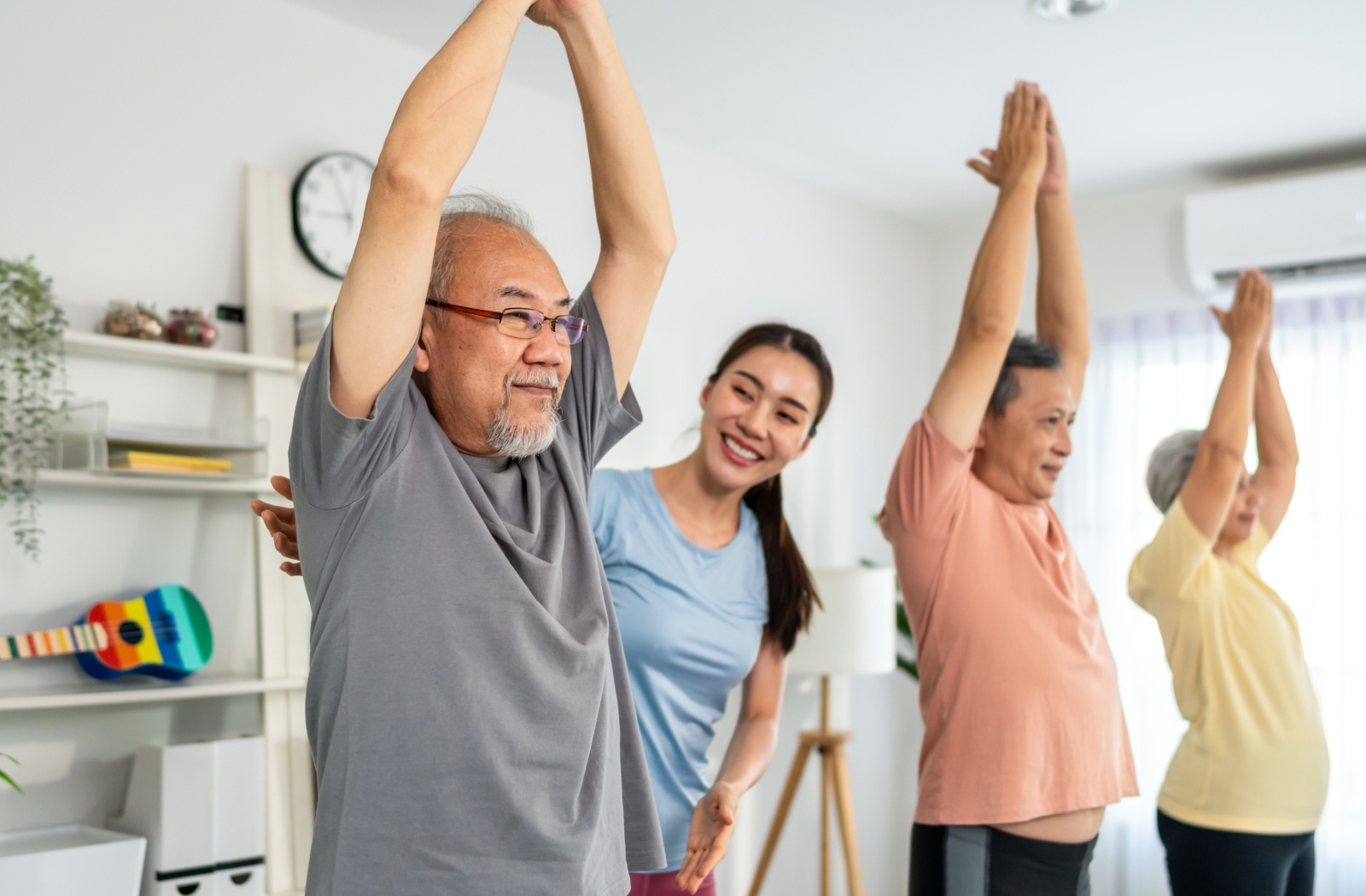 A group of senior residents attend a yoga class at a senior living community.