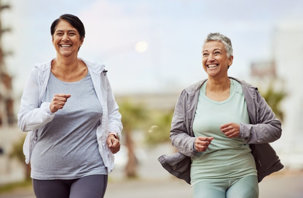 Two senior friends go for a light jog together.